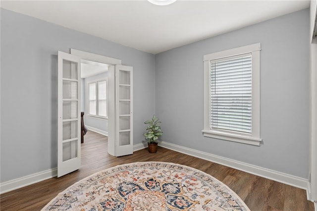 6927 Lansdowne Ave, Saint Louis, MO 63109 - empty room with french doors, wood finished floors, and baseboards