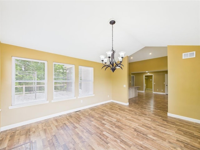 14800 County Road 448, St James, MO 65559 - empty room featuring lofted ceiling, light wood-style flooring, a chandelier, and baseboards
