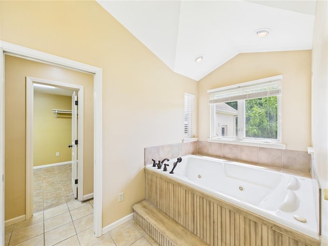 14800 County Road 448, St James, MO 65559 - bathroom with a whirlpool tub, vaulted ceiling, tile patterned flooring, and baseboards