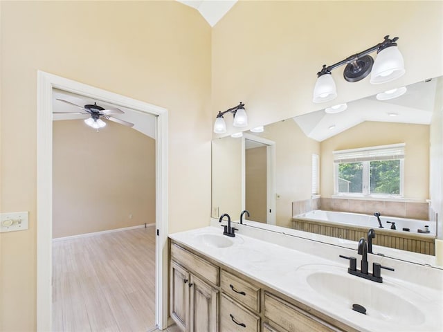14800 County Road 448, St James, MO 65559 - bathroom featuring lofted ceiling, a bath, double vanity, ceiling fan, and wood finished floors