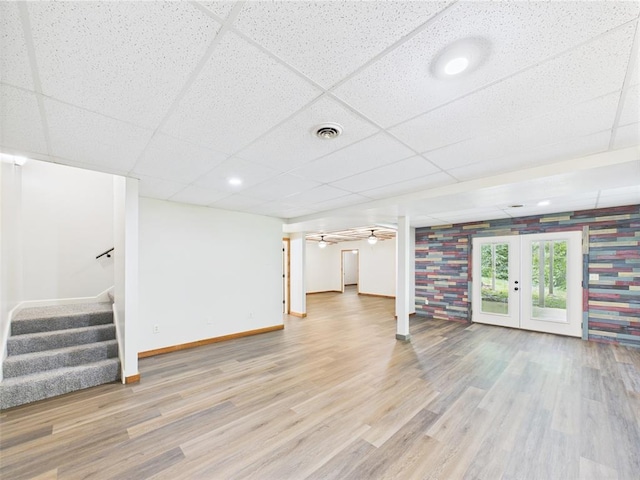 14800 County Road 448, St James, MO 65559 - unfurnished living room with french doors, a drop ceiling, stairs, wood finished floors, and baseboards