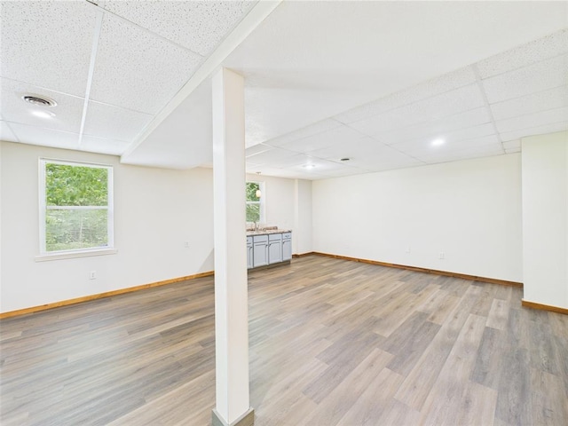 14800 County Road 448, St James, MO 65559 - below grade area with a drop ceiling, baseboards, and wood finished floors