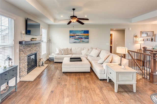 223 Ellington Ct, Glen Carbon, IL 62034 - living room featuring a ceiling fan, light wood-style floors, a stone fireplace, recessed lighting, and baseboards