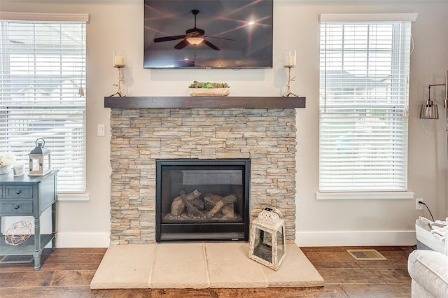 223 Ellington Ct, Glen Carbon, IL 62034 - living room with baseboards, wood finished floors, a ceiling fan, and a stone fireplace