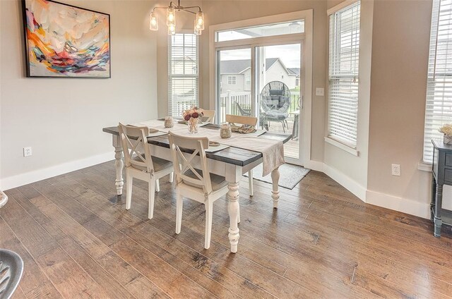 223 Ellington Ct, Glen Carbon, IL 62034 - dining space featuring healthy amount of natural light, wood finished floors, baseboards, and a chandelier