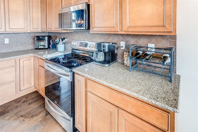 223 Ellington Ct, Glen Carbon, IL 62034 - kitchen featuring stainless steel appliances, decorative backsplash, and light stone counters
