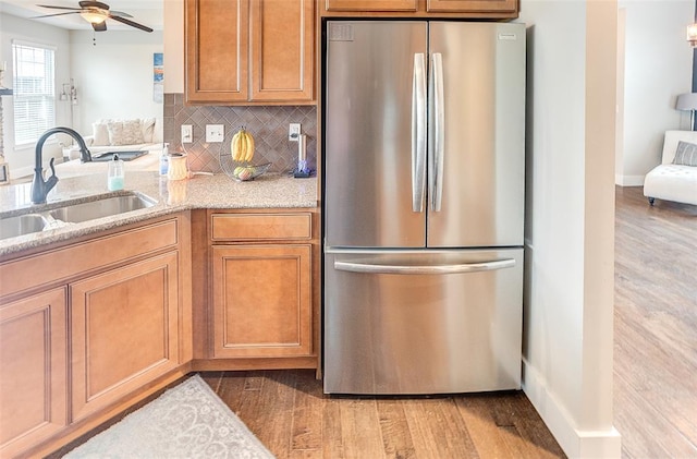 223 Ellington Ct, Glen Carbon, IL 62034 - kitchen with freestanding refrigerator, a sink, light wood-style floors, and light stone countertops