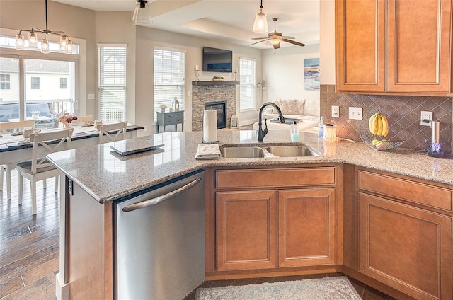 223 Ellington Ct, Glen Carbon, IL 62034 - kitchen featuring dishwasher, a sink, open floor plan, a ceiling fan, and brown cabinets