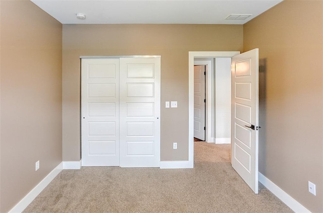223 Ellington Ct, Glen Carbon, IL 62034 - unfurnished bedroom featuring light colored carpet, a closet, and baseboards