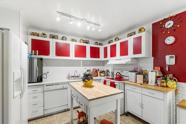 930 Laredo Ave, Saint Louis, MO 63138 - kitchen with white appliances, wood counters, under cabinet range hood, a sink, and tasteful backsplash