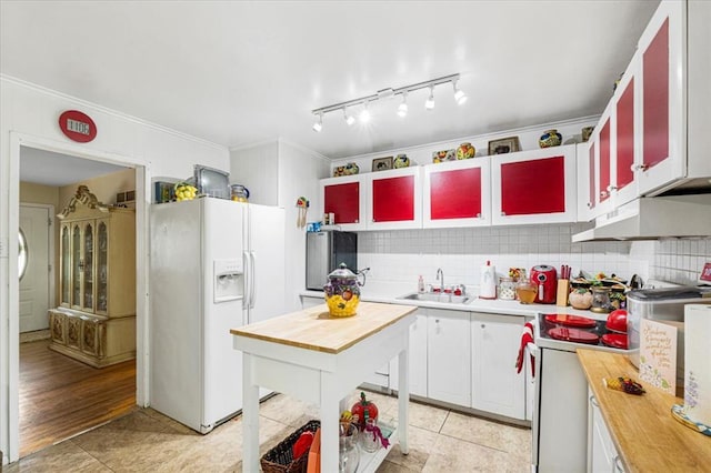 930 Laredo Ave, Saint Louis, MO 63138 - kitchen with white fridge with ice dispenser, wood counters, a sink, under cabinet range hood, and ornamental molding