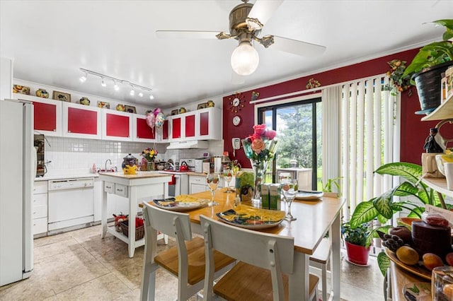 930 Laredo Ave, Saint Louis, MO 63138 - kitchen with white appliances, backsplash, under cabinet range hood, light countertops, and a ceiling fan
