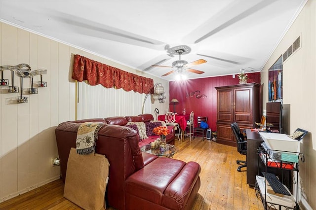930 Laredo Ave, Saint Louis, MO 63138 - living room featuring a desk, light wood-style floors, ceiling fan, ornamental molding, and wooden walls