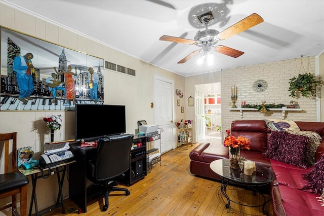 930 Laredo Ave, Saint Louis, MO 63138 - living area featuring hardwood / wood-style floors, ceiling fan, an office area, brick wall, and ornamental molding