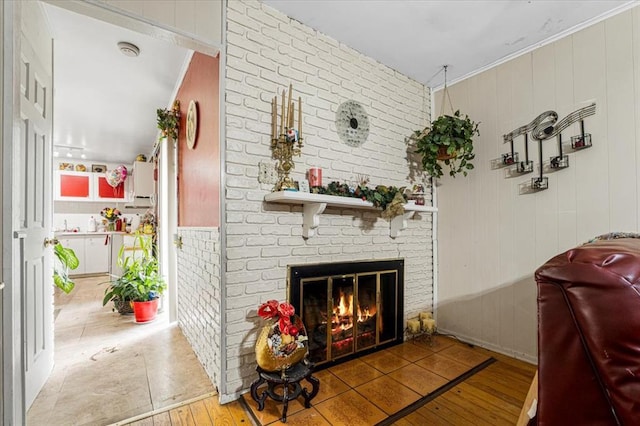 930 Laredo Ave, Saint Louis, MO 63138 - living area with hardwood / wood-style flooring, a fireplace, crown molding, and wood walls
