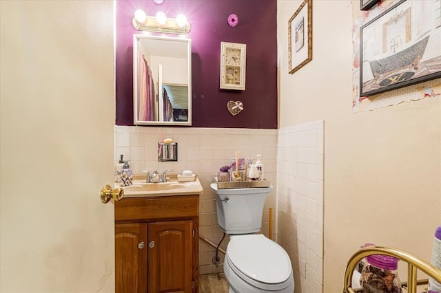 930 Laredo Ave, Saint Louis, MO 63138 - bathroom with toilet, vanity, tile walls, and wainscoting