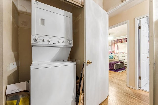 930 Laredo Ave, Saint Louis, MO 63138 - laundry area featuring stacked washer and clothes dryer and light wood-style flooring