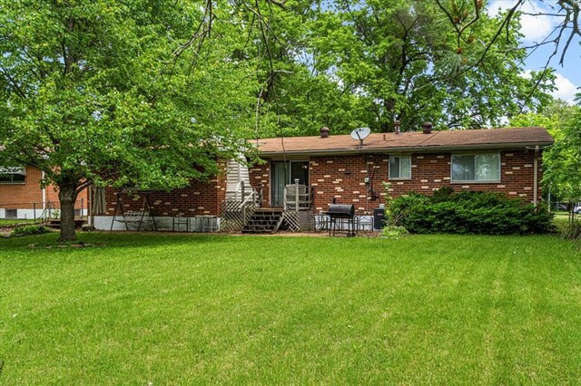 930 Laredo Ave, Saint Louis, MO 63138 - rear view of house with a yard and brick siding