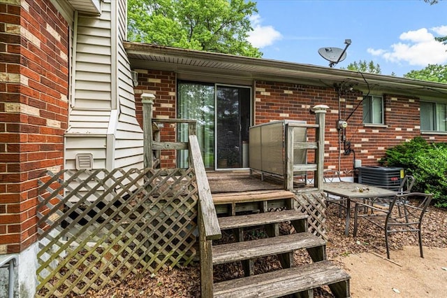930 Laredo Ave, Saint Louis, MO 63138 - doorway to property with brick siding, a deck, and cooling unit