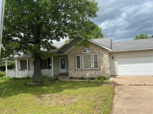 14345 Howard Ln, Dixon, MO 65459 - ranch-style home featuring stone siding, concrete driveway, a porch, an attached garage, and a front lawn