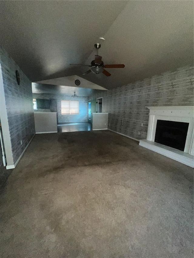 14345 Howard Ln, Dixon, MO 65459 - unfurnished living room with carpet floors, lofted ceiling, a fireplace with raised hearth, a ceiling fan, and baseboards