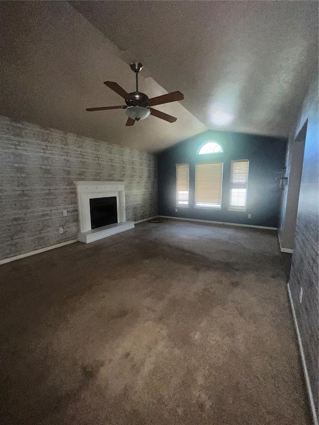 14345 Howard Ln, Dixon, MO 65459 - unfurnished living room with a ceiling fan, carpet flooring, baseboards, lofted ceiling, and a fireplace with raised hearth