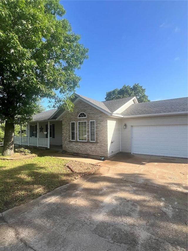 14345 Howard Ln, Dixon, MO 65459 - ranch-style home with driveway, a garage, a porch, a shingled roof, and stone siding