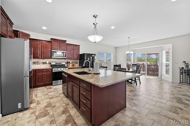 38 Crystal Manor Ct, Wentzville, MO 63385 - kitchen with appliances with stainless steel finishes, a sink, backsplash, pendant lighting, and an island with sink
