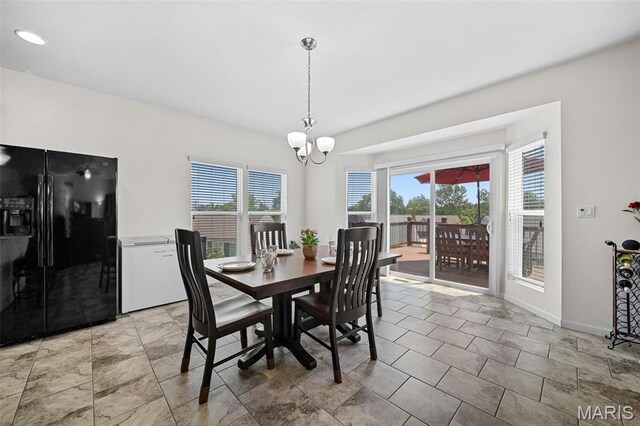 38 Crystal Manor Ct, Wentzville, MO 63385 - dining space with a chandelier and baseboards
