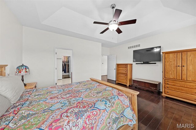 38 Crystal Manor Ct, Wentzville, MO 63385 - bedroom featuring dark wood finished floors, a tray ceiling, and ceiling fan