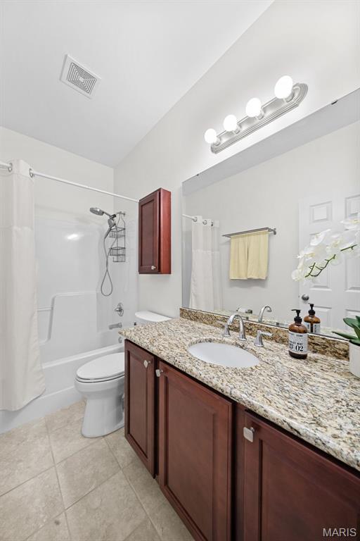 38 Crystal Manor Ct, Wentzville, MO 63385 - bathroom featuring toilet, vanity, tile patterned floors, and shower / bathtub combination with curtain