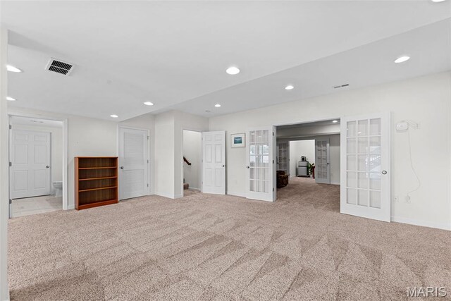 38 Crystal Manor Ct, Wentzville, MO 63385 - unfurnished living room featuring french doors, carpet floors, baseboards, recessed lighting, and stairway