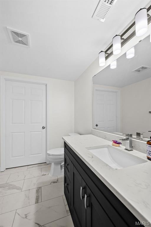 38 Crystal Manor Ct, Wentzville, MO 63385 - bathroom with vanity, marble finish flooring, and toilet