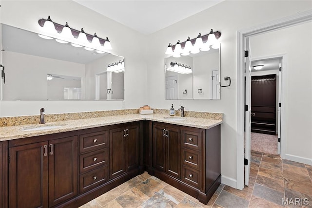 38 Crystal Manor Ct, Wentzville, MO 63385 - full bathroom featuring stone tile floors, double vanity, baseboards, and ceiling fan