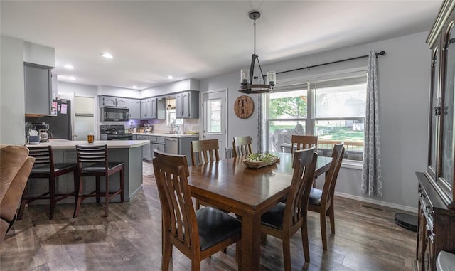20336 Scholar Ln, Waynesville, MO 65583 - dining area with dark wood-type flooring, a chandelier, recessed lighting, and baseboards