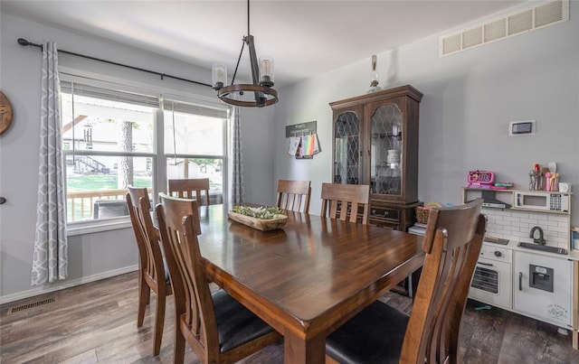 20336 Scholar Ln, Waynesville, MO 65583 - dining room with a chandelier, dark wood-style flooring, and baseboards