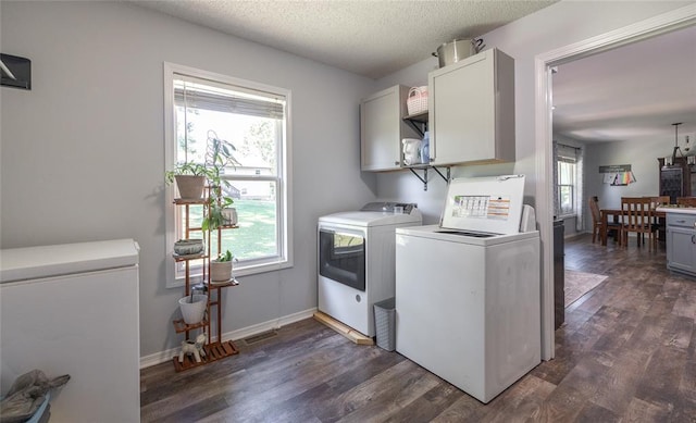 20336 Scholar Ln, Waynesville, MO 65583 - washroom featuring cabinet space, washing machine and clothes dryer, dark wood-type flooring, baseboards, and a textured ceiling