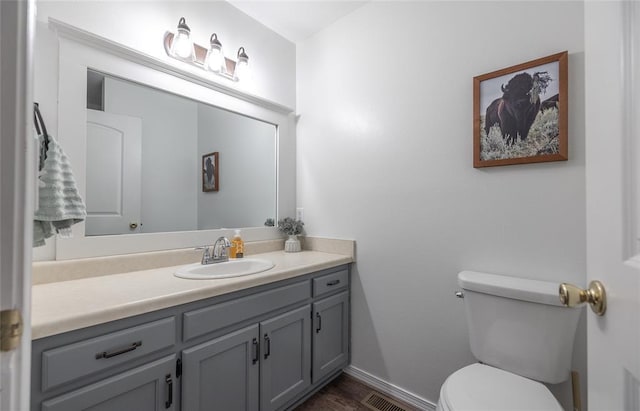 20336 Scholar Ln, Waynesville, MO 65583 - half bathroom with vanity, toilet, baseboards, and wood finished floors