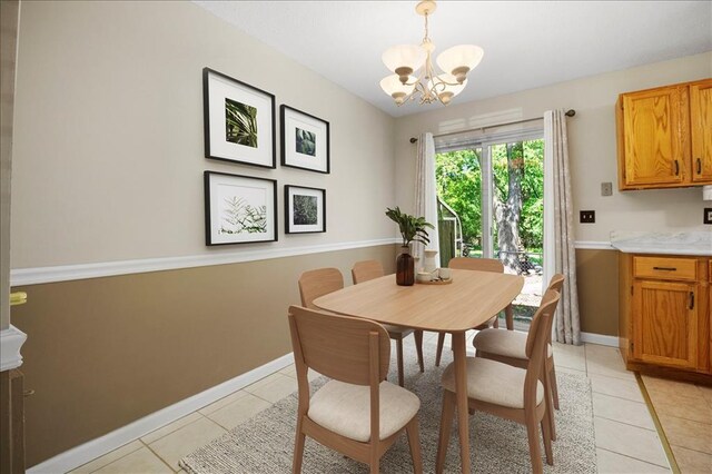 11846 Sologne Ct, Maryland Heights, MO 63043 - dining room featuring light tile patterned floors, a chandelier, and baseboards