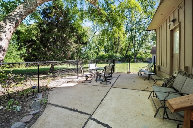 11846 Sologne Ct, Maryland Heights, MO 63043 - view of patio featuring outdoor dining area and view of scattered trees