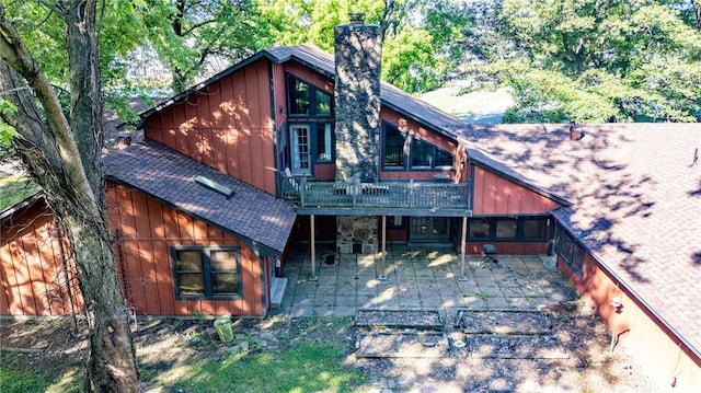 22 Greenbriar Dr, New Madrid, MO 63869 - back of house with a patio, a chimney, a shingled roof, and a deck