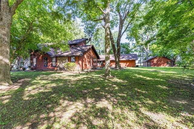 22 Greenbriar Dr, New Madrid, MO 63869 - rear view of property featuring a lawn