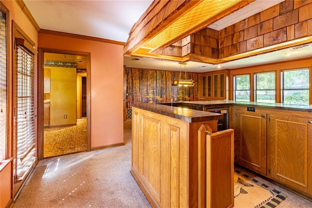 22 Greenbriar Dr, New Madrid, MO 63869 - kitchen featuring beverage cooler, dark countertops, crown molding, light colored carpet, and hanging light fixtures