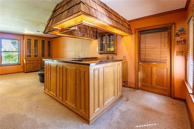 22 Greenbriar Dr, New Madrid, MO 63869 - kitchen with light colored carpet, brown cabinets, glass insert cabinets, baseboards, and ornamental molding