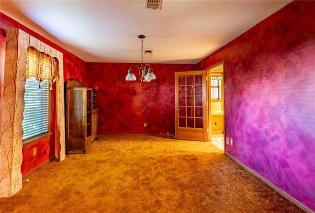 22 Greenbriar Dr, New Madrid, MO 63869 - spare room with healthy amount of natural light, carpet flooring, and a chandelier