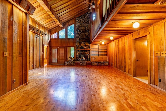 22 Greenbriar Dr, New Madrid, MO 63869 - unfurnished living room with high vaulted ceiling, wood walls, wood-type flooring, wooden ceiling, and ceiling fan