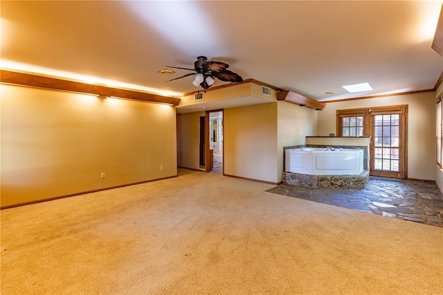 22 Greenbriar Dr, New Madrid, MO 63869 - unfurnished living room with carpet floors, a ceiling fan, baseboards, and a skylight