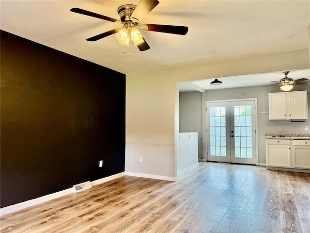 7729 Humbert Rd, Godfrey, IL 62035 - unfurnished room featuring french doors, a ceiling fan, light wood-style floors, and baseboards
