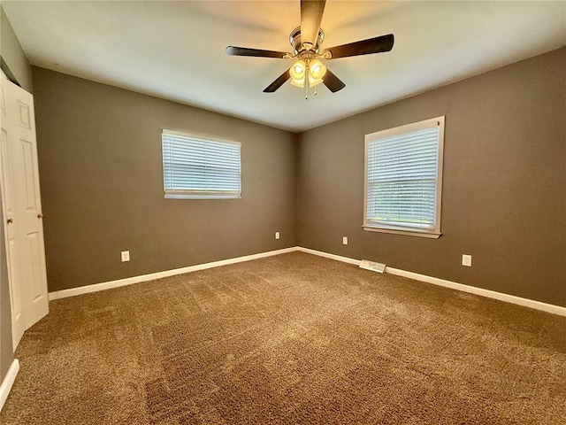 7729 Humbert Rd, Godfrey, IL 62035 - empty room featuring carpet flooring, baseboards, and ceiling fan