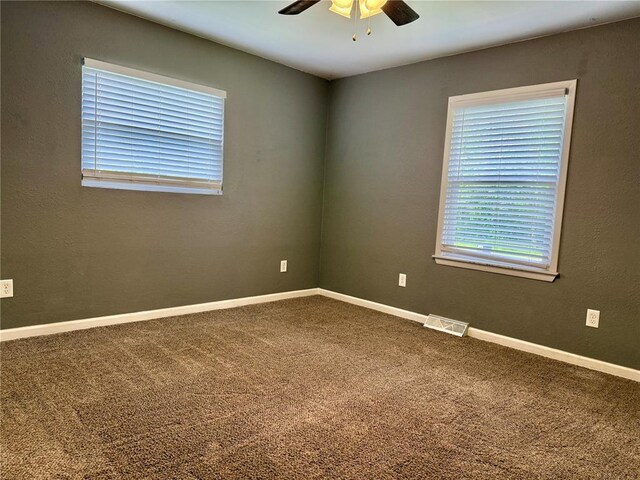 7729 Humbert Rd, Godfrey, IL 62035 - spare room with ceiling fan, carpet flooring, and baseboards
